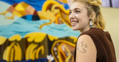 Female student in front of colourful mosaic