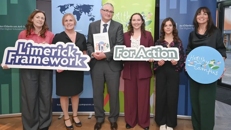 Photo of group of 6 people holding boards reading Limerick Framework for action and Healthy Campus