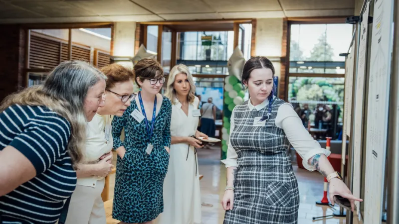 Group looking at an exhibition poster