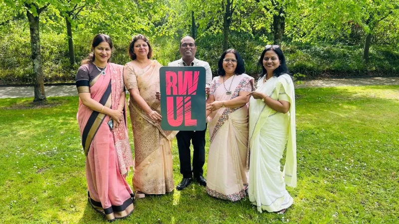MGM Uni delegates holding an RW UL sign