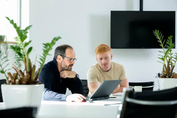 Image of two people looking at a laptop in the Nexus Innovation Centre