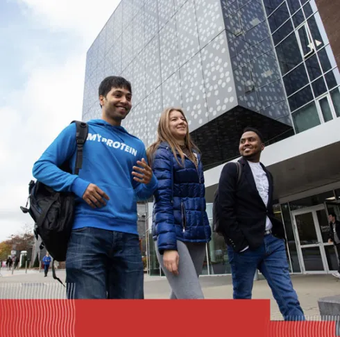 3 mature students walking on campus