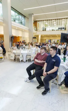 Groups of men and women sitting at round tables